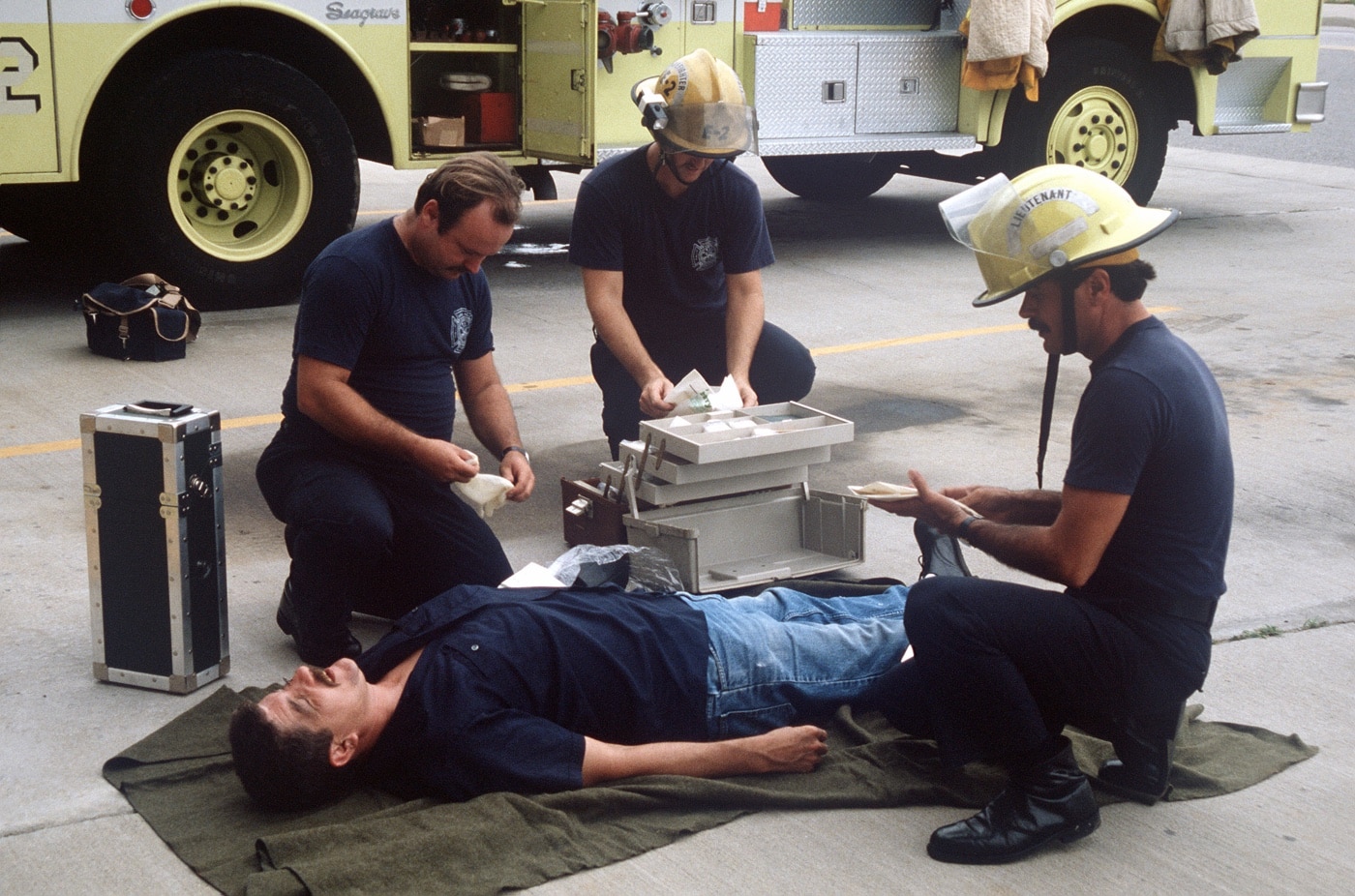 firefighter paramedics assess a patient for injuries