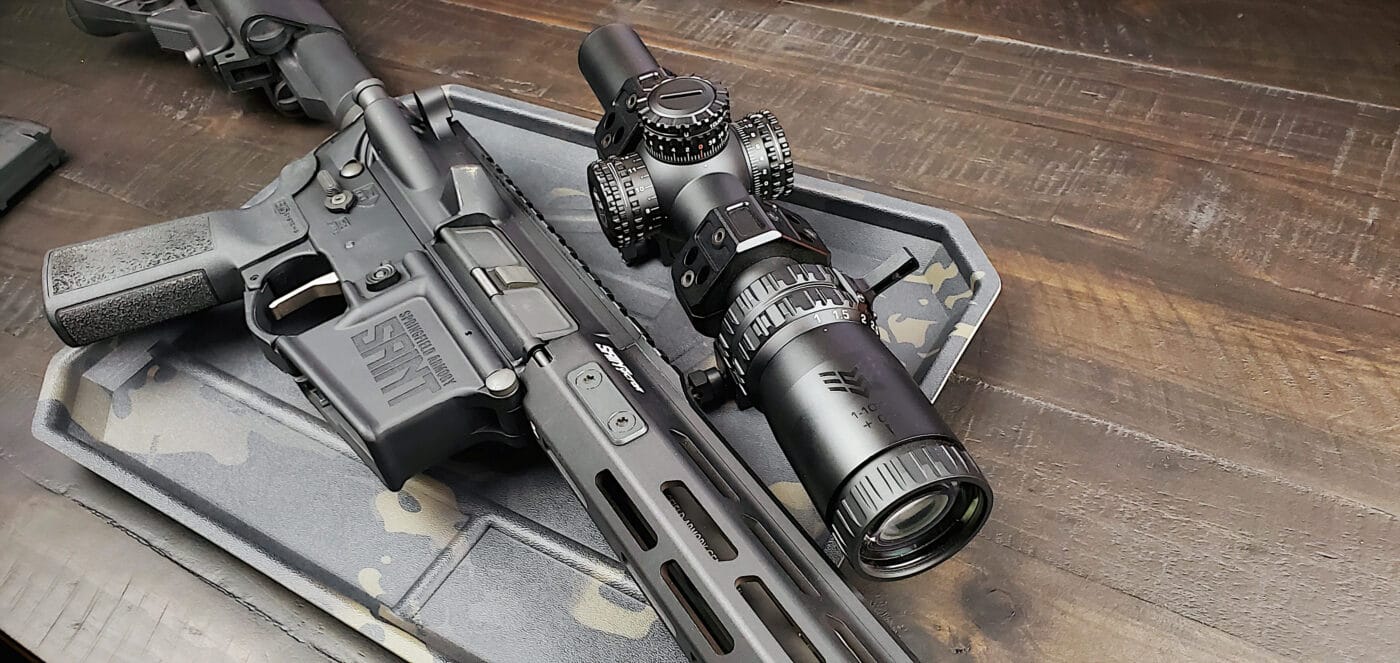 Swampfox Arrowhead rifle scope next to a SAINT rifle