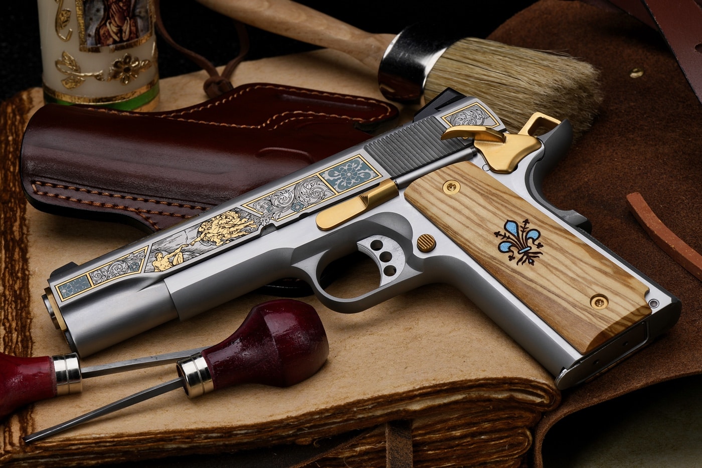 Shown is the left side of the Michelangelo 1911 handgun. On the slide is a recreation of the Creation of Adam.