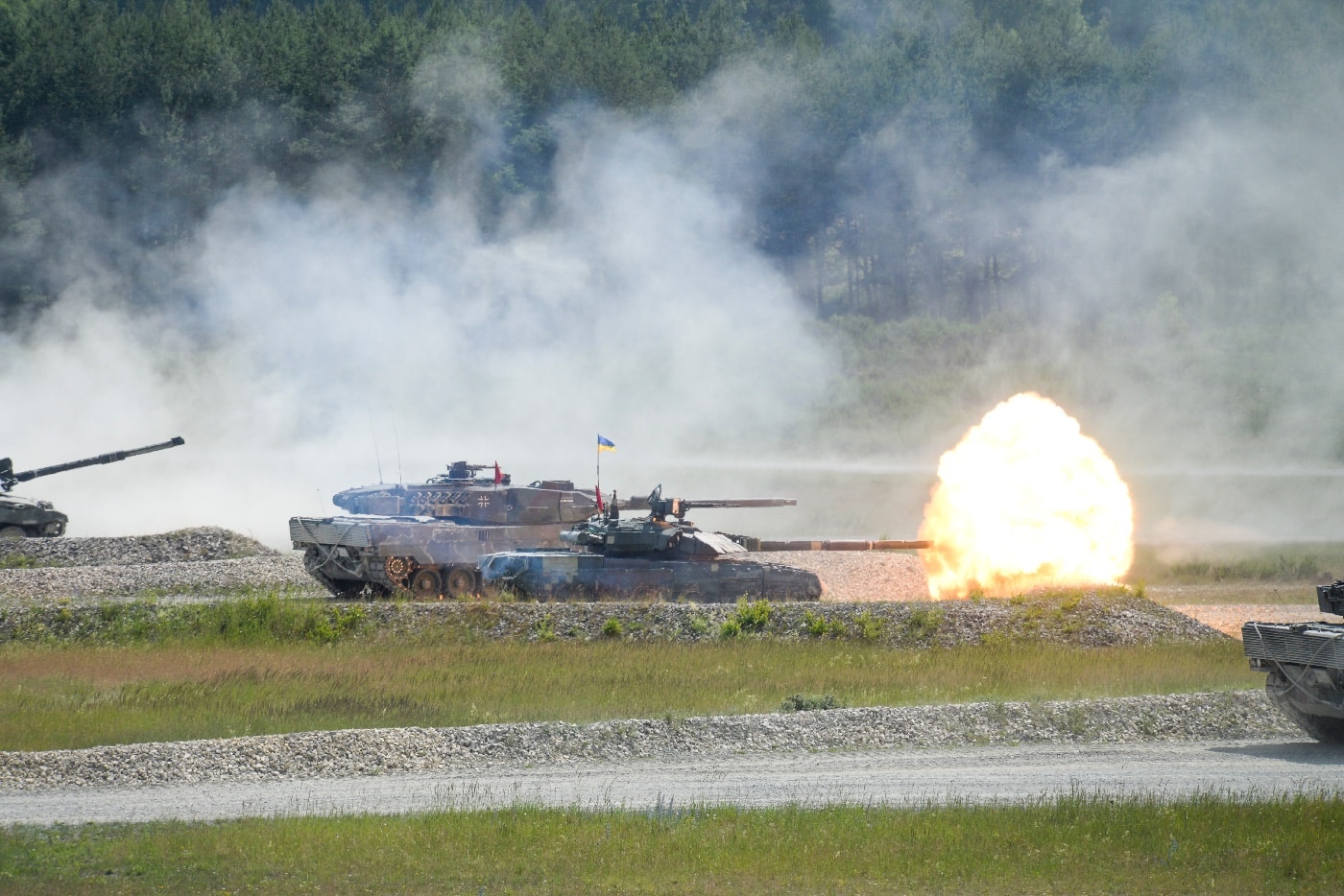 In this photo, we see both Ukrainian T-84 and German Leopard II tanks firing their guns during a training exercise in Germany. The T-84 is smaller than the Leopard II tank.