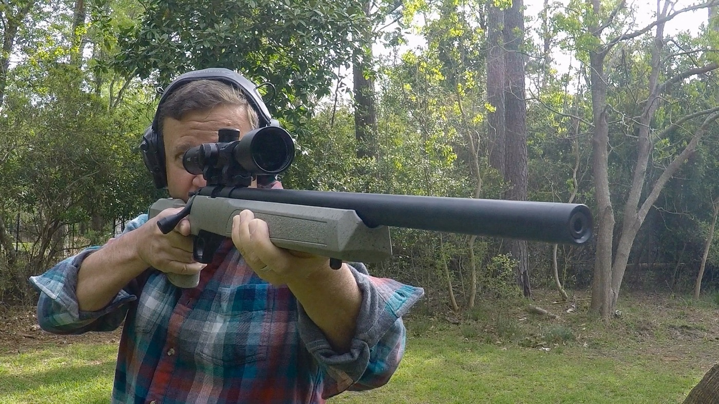 In this photograph, the author is testing the Hawke rimfire scope on the shooting range with 40 grain .22 Long Rifle ammo. The bolt-action Springfield Armory Model 2020 Rimfire.