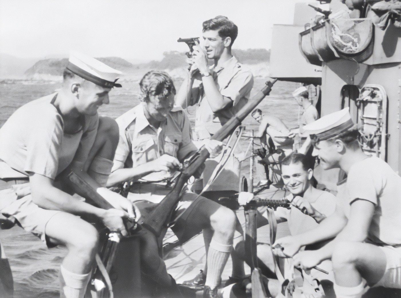 Australian soldiers clean weapons prior to landing in Japan during WWII