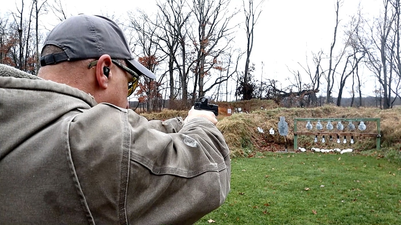 In this photograph, the writer Dan Abraham tests the Burris FastFire C on the shooting range. The author found it easy to hit the steel targets. The FastFire C allows for rapid transitions between targets.