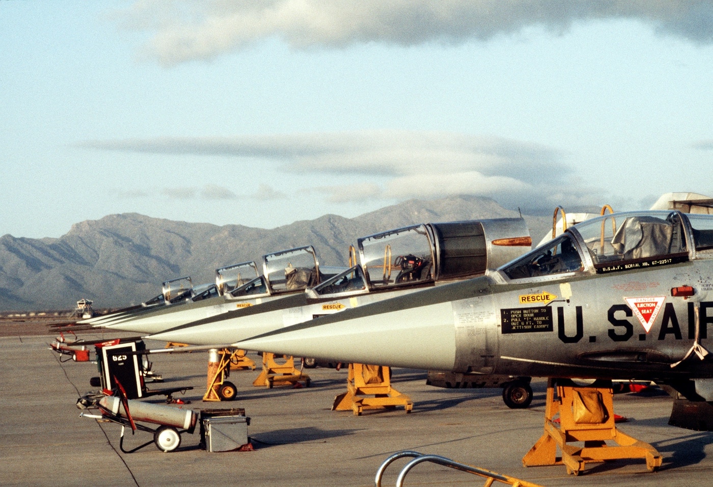 In this image we see Lockheed F-104G Starfighter aircraft parked on the flight line during the training of German military pilots in 1982.