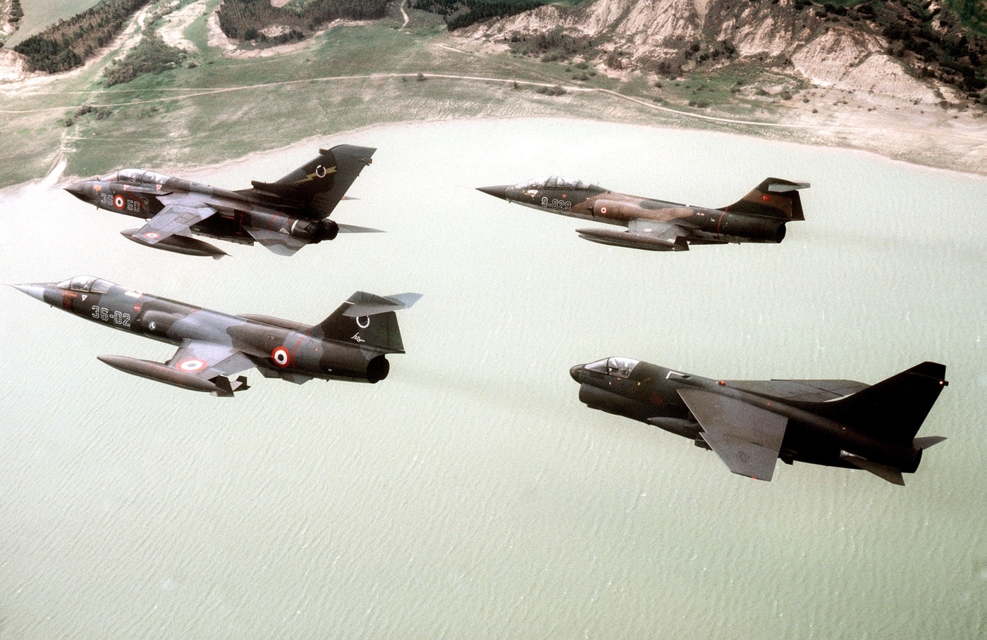 Shown here are an Italian F-104 Starfighter, an Italian Tornado, a Turkish F-104 Starfighter and a U.S. A-7D Corsair II in formation during NATO exercise Dragon Hammer '87.