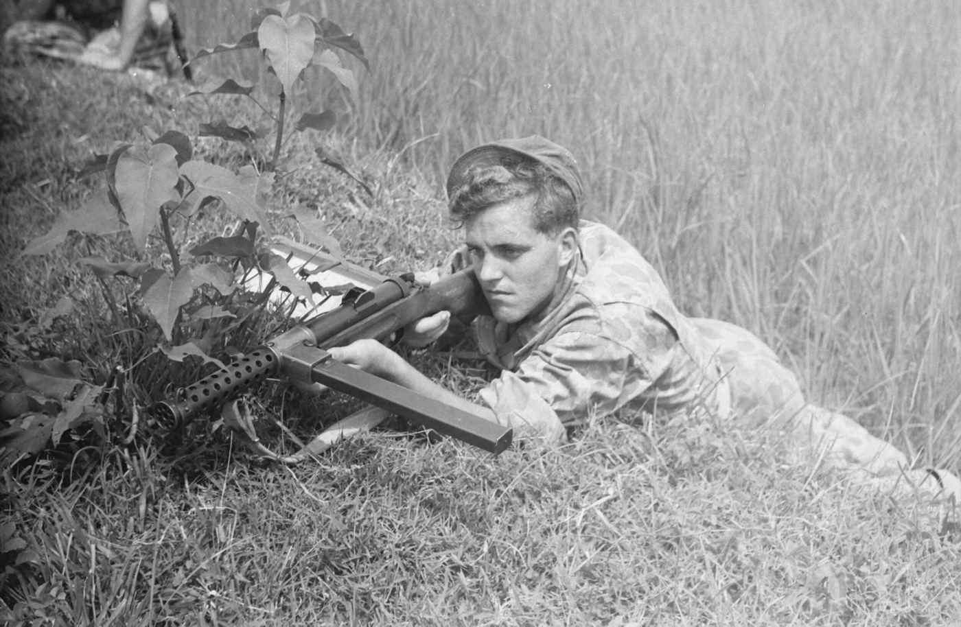Netherlands soldier prone with Lanchester submachine gun in war