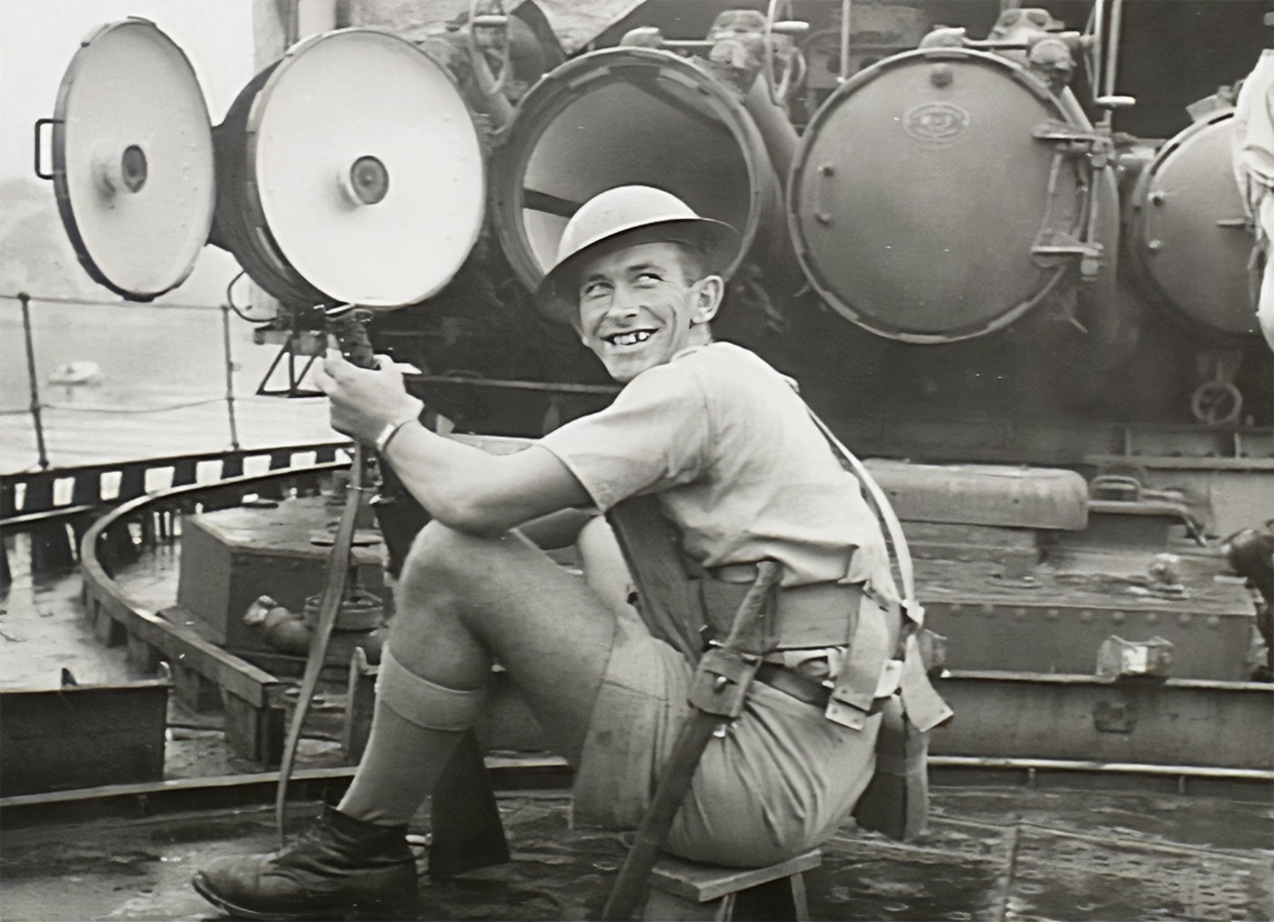 Royal Australian Navy sailor on captured Japanese ship with Lanchester SMG