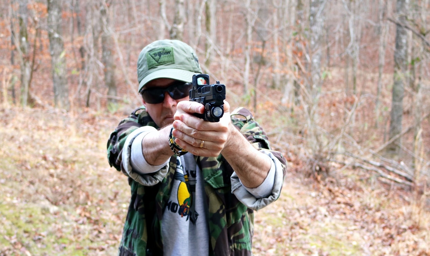 In this photo, the writer Dr. Will Dabbs is shooting the Echelon with a mounted RCR closed emitter optic on a shooting range. Built tougher than the problematic SIG Sauer handguns, the Echelon natively mounts red-dot sights and will not rust when exposed to salt air. 