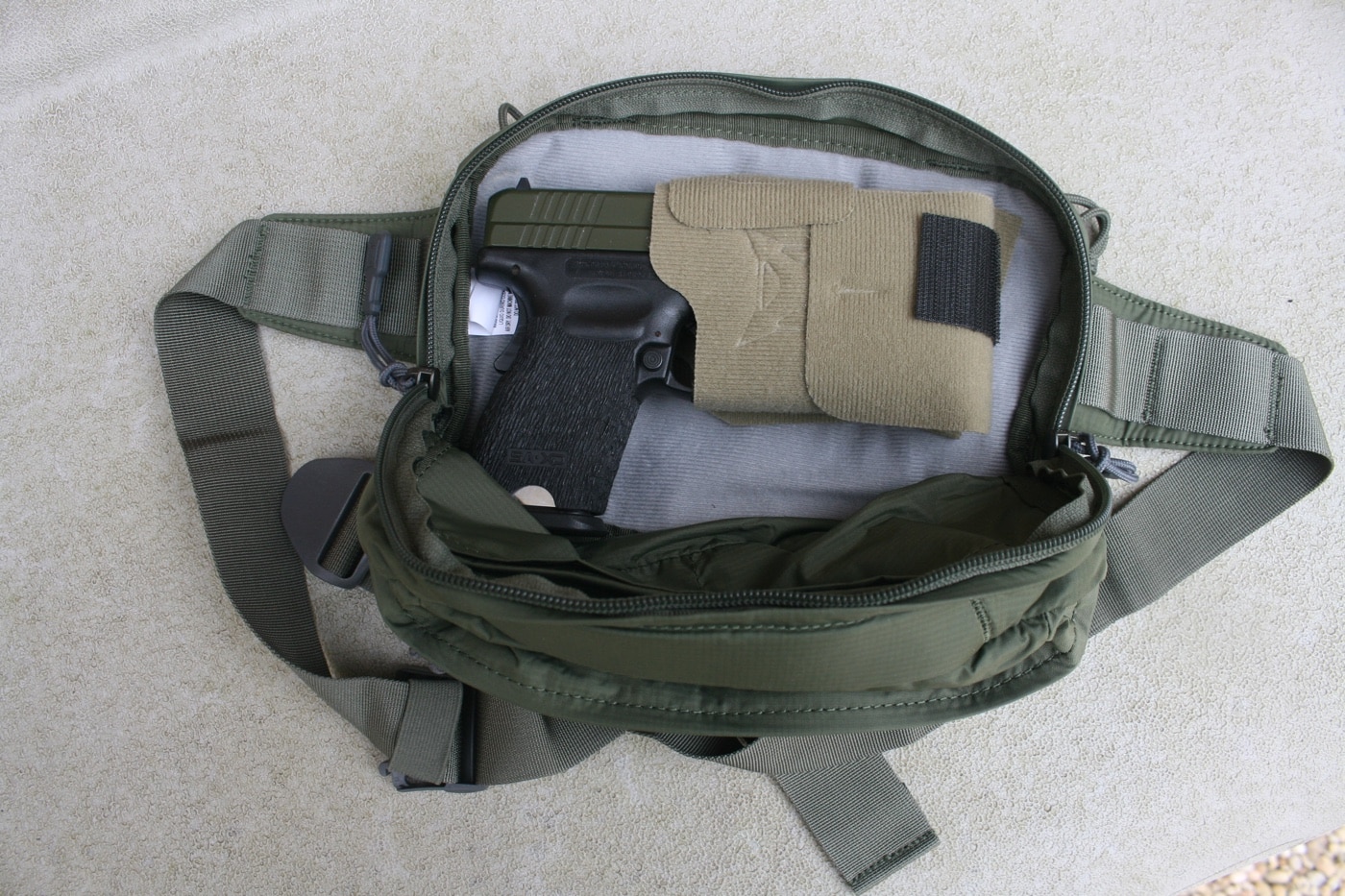 Shown in this photo is a Springfield Armory XD Service Model in 9x19mm Parabellum that is carried in an off-body bag or fanny pack for personal protection by a retired police officer.