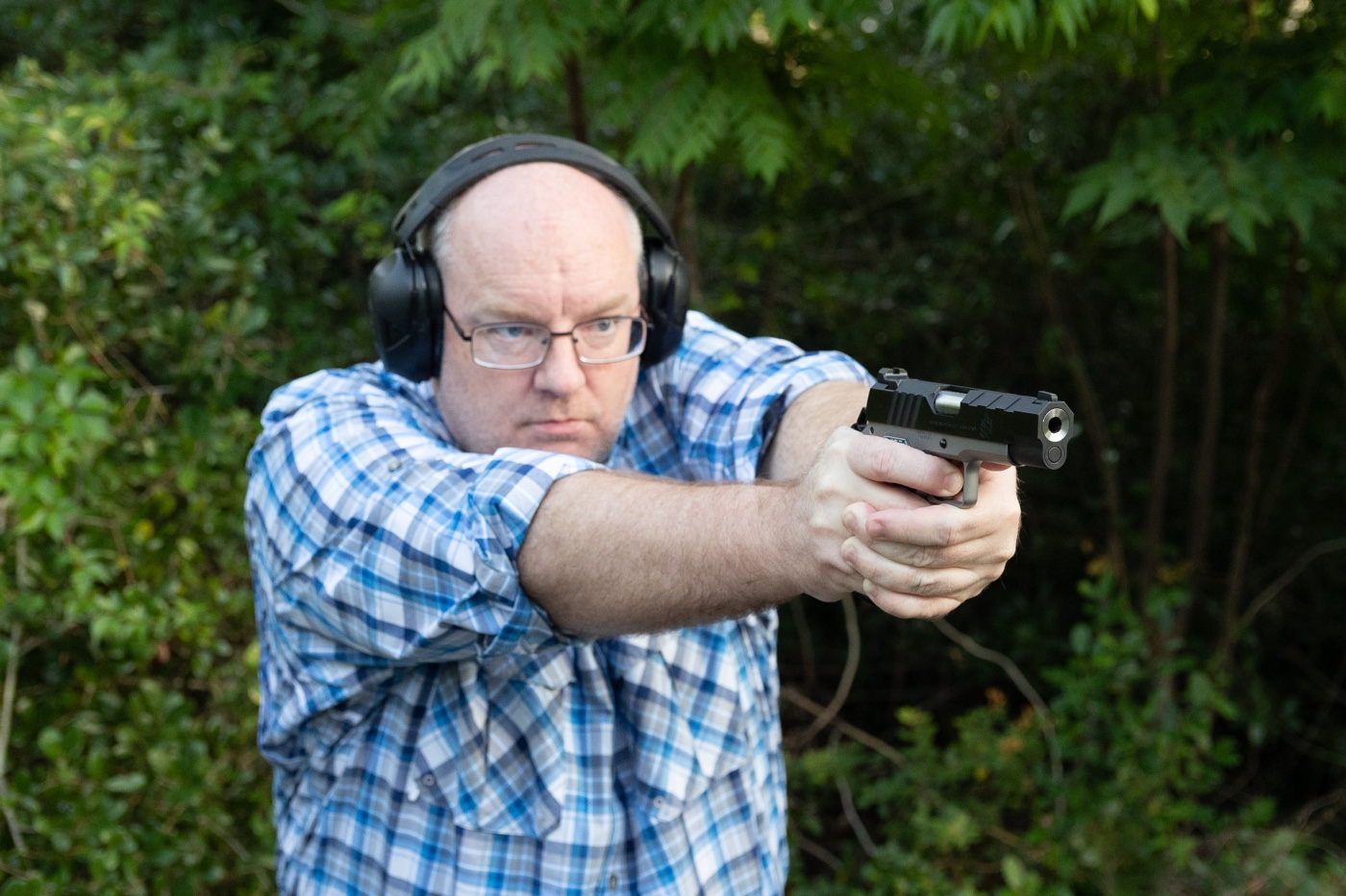 Shown here is Richard Johnson, the managing editor of The Armory Life, shooting a Springfield Armory Emissary 1911 pistol. The Springfield 1911 is a modern version of the M1911 pistol used by the United States of America.