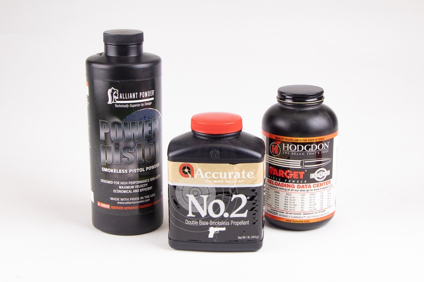 In this photograph, we see three different bottles of smokeless powder developed for handgun cartridges. We see smokeless powder for reloading cartridges from Alliant Powder, Hodgdon and Accurate. Each formulation offers different benefits.