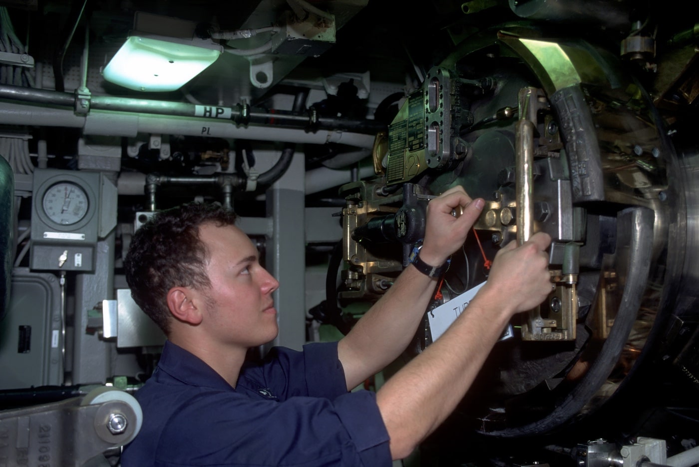 torpedoman checking torpedo tubes of USS Pennsylvania