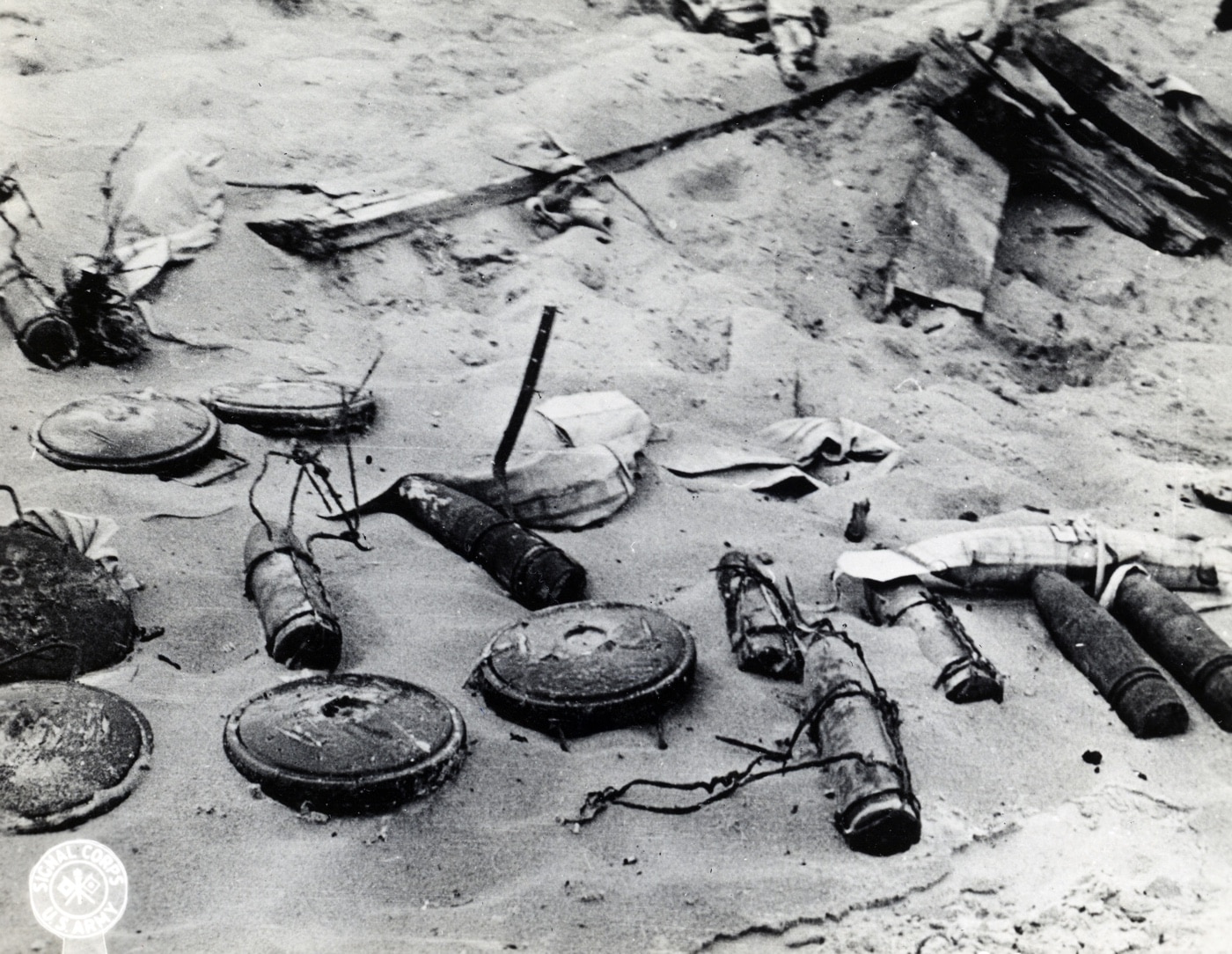 Shown in this photograph is a variety of German mines used in Normandy France. Soldiers landing in Operation Neptune had to be prepared for these Atlantic Wall defenses.