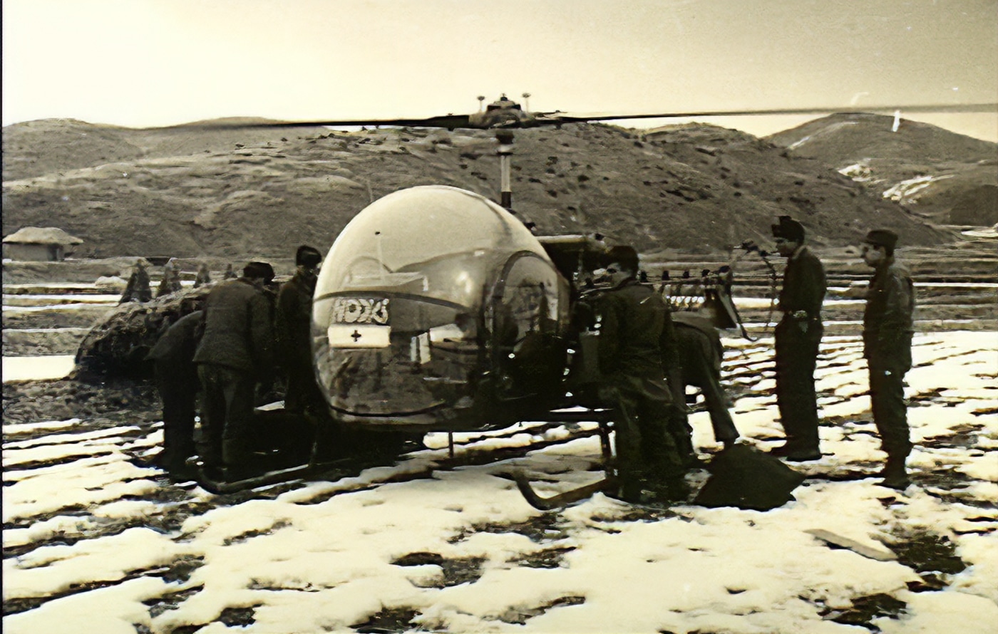 wounded Australian soldier loaded on US Army Bell H-13 Sioux helicopter