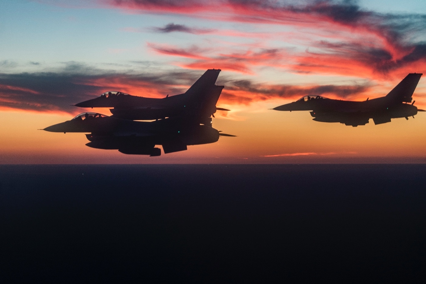 F-16 Fighting Falcons fly in formation over Niceville High School football game