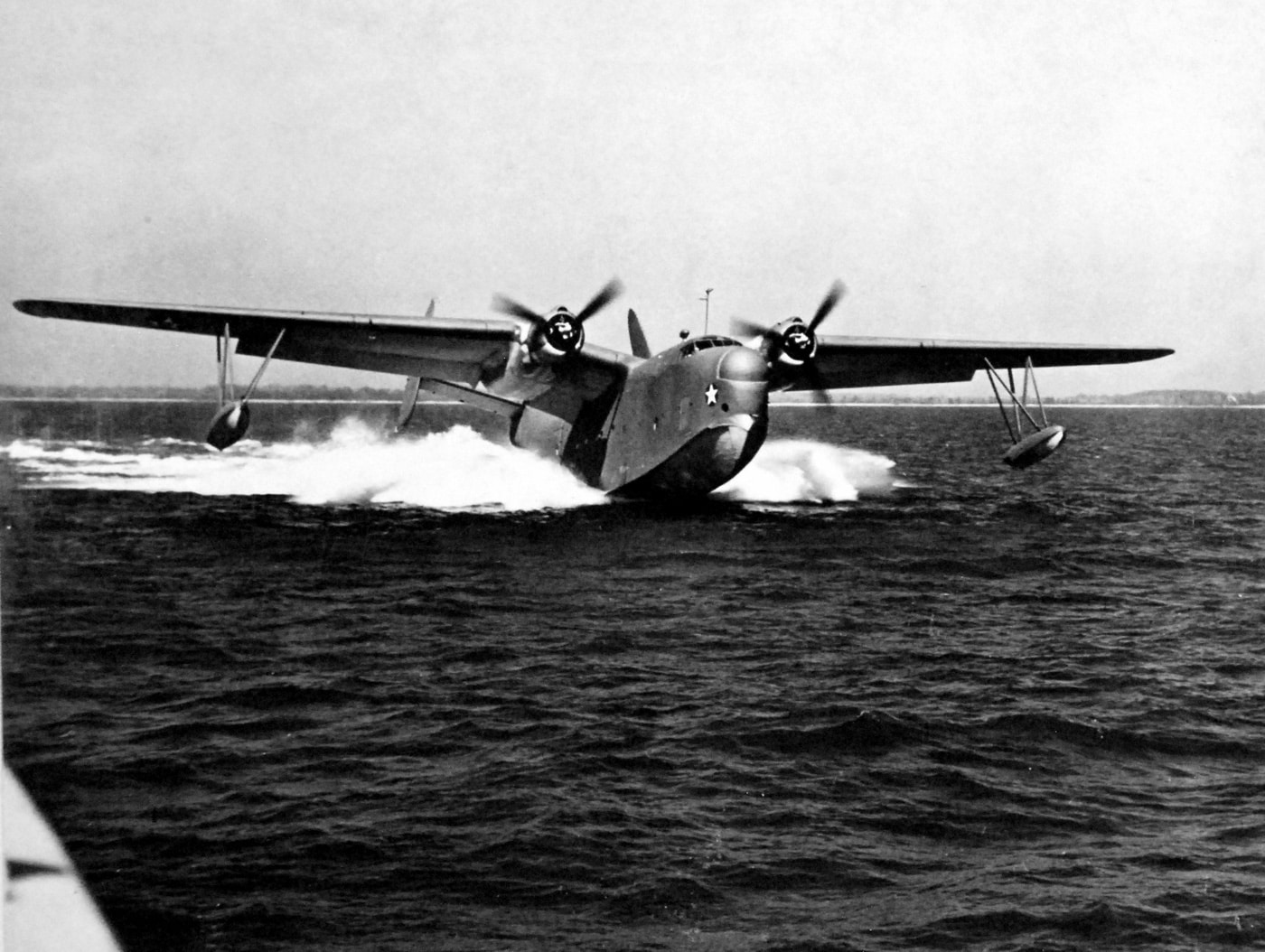 In this image, a Martin PBM-3 Mariner lands on the water. The black and white photo was taken in 1943 for the U.S. Navy.