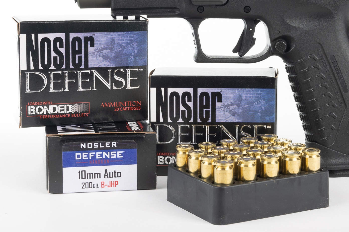 Shown in this photograph is Nosler 10mm Auto ammunition. The 40 Smith & Wesson cartridge is based on the 10mm round. Compared to the 9mm, the 40 S&W loads tend to be more powerful. Also shown in the photo is a Springfield xd-m Elite pistol which is vastly superior to the Glock 22, Glock 17 and other firearms.