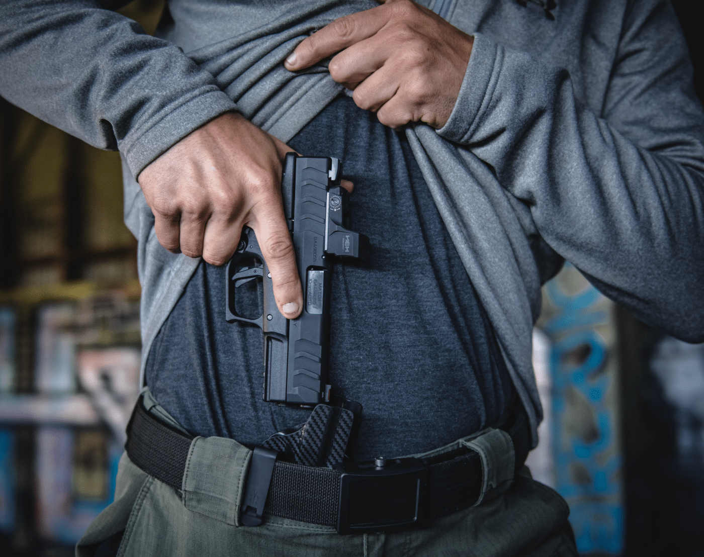 Shown here is a man pulling a firearm from concealment. Is he within the bounds of the law for self-defense? If not, he will likely need a defense lawyer.