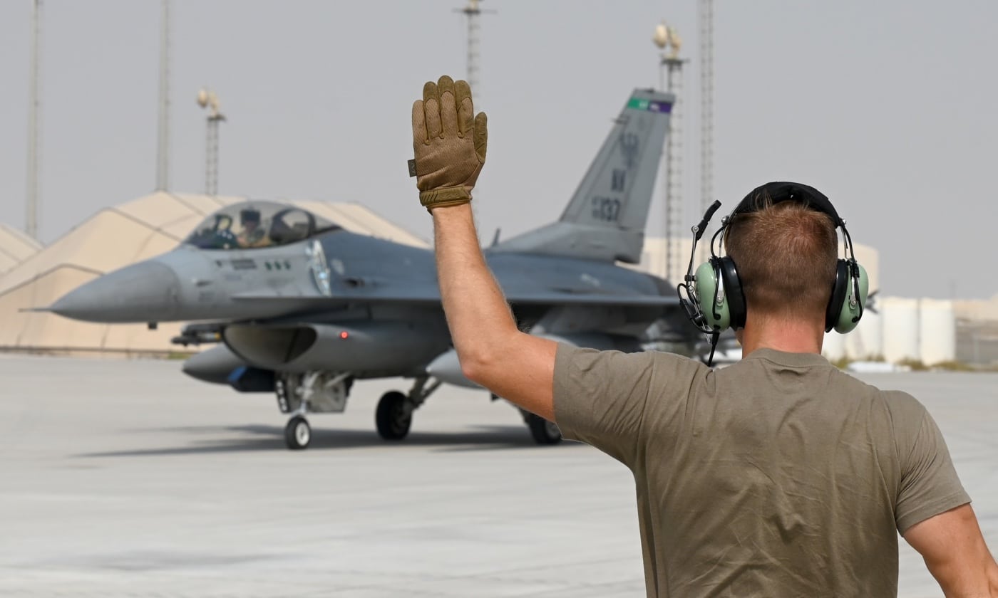 USAF airman marshals an F-16 in United Arab Emirates