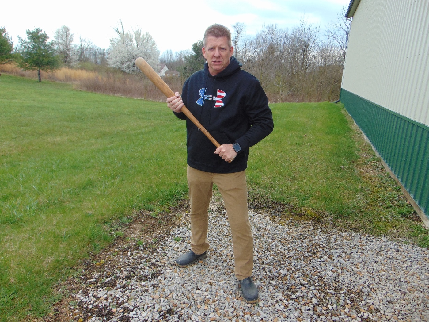 In this image, the author holds a baseball bat as a weapon. Brandishing a weapon that is not a gun can still be considered a crime and you might be charged with a misdemeanor or felony.