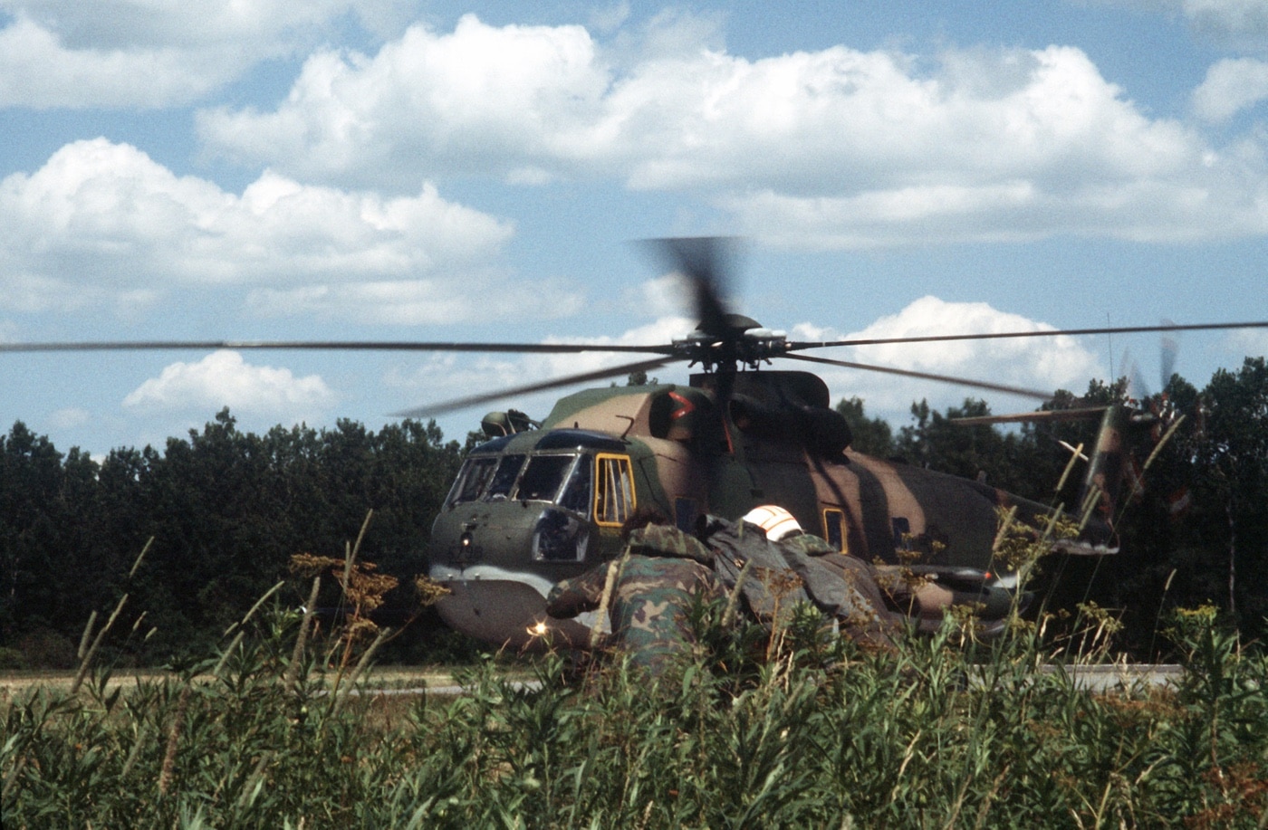 pararescue specialists rescue an injured pilot using an HH-3 Jolly Green Giant helicopter in training