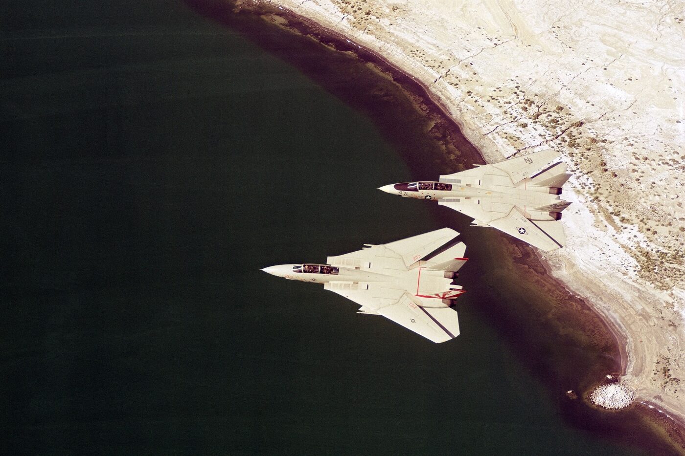 F-14 Tomcat fighters flying in formation over the coastline