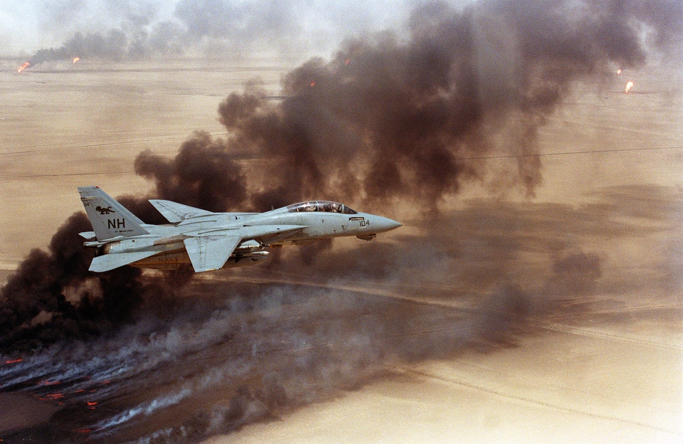 F-14 flies over Kuwaiti oil fields set on fire by Iraq during Operation Desert Storm