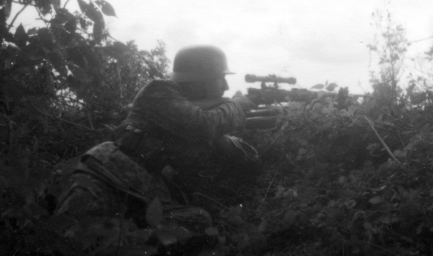 German SS sniper in hedgerow brush in Normandy