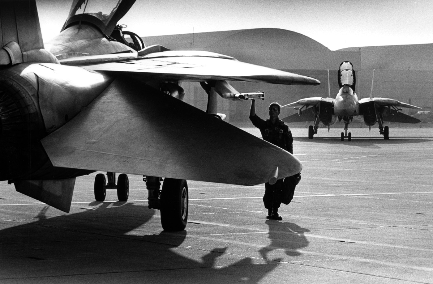 Lt Craig Steffen of VF-211 stands next to F-14 Tomcat in Top Gun