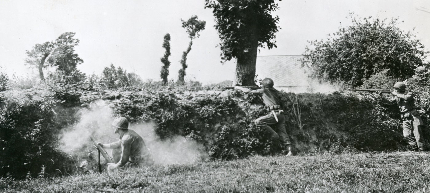 US Army soldiers firing M1 Garand rifles in Normandy hedgerows