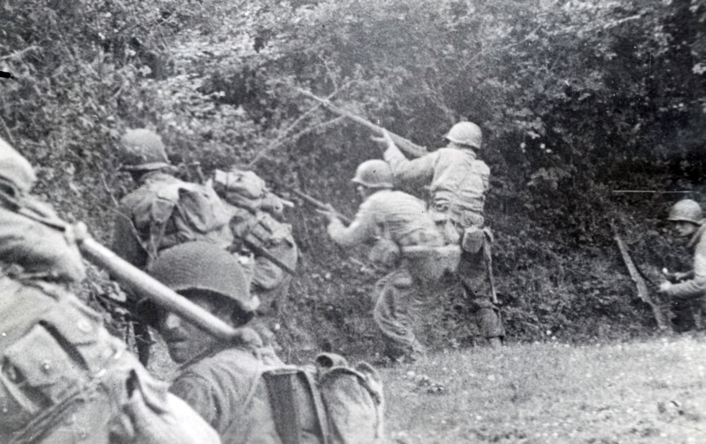 US infantry advances through a hedgerow