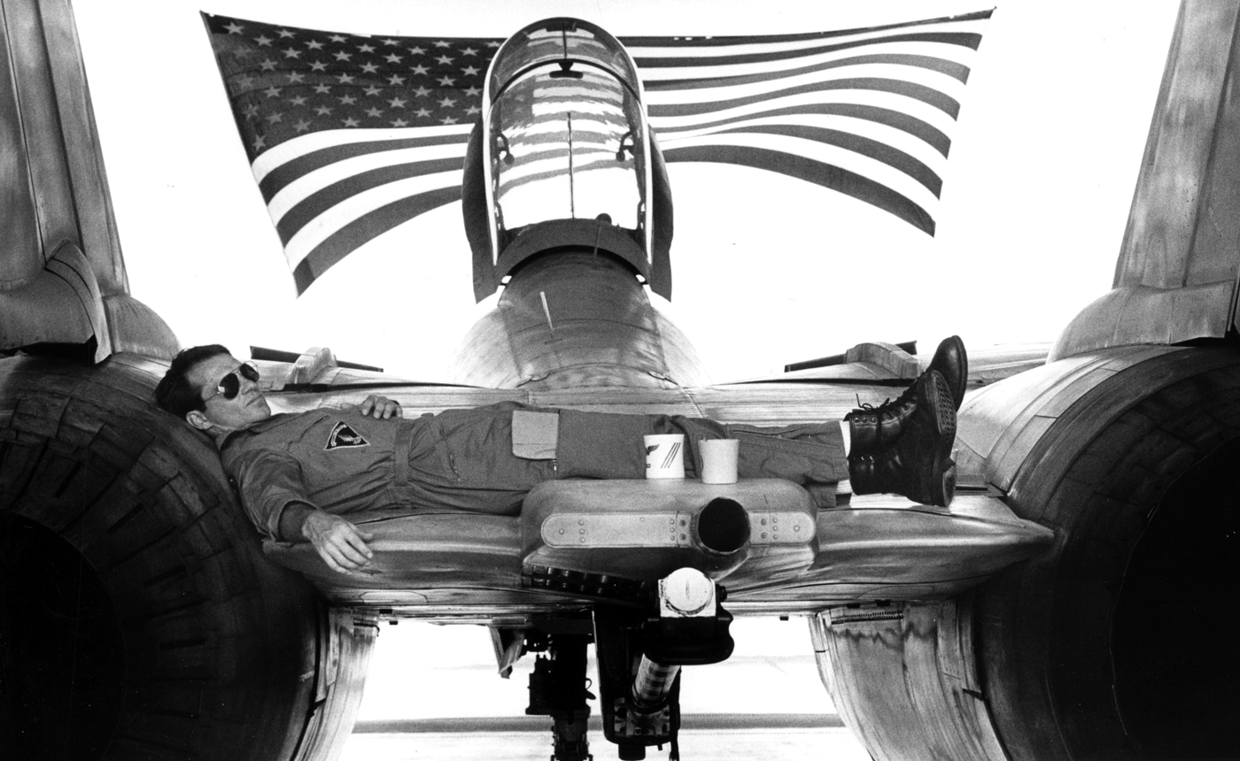 USN pilot rests on a F-14 Tomcat used in Top Gun