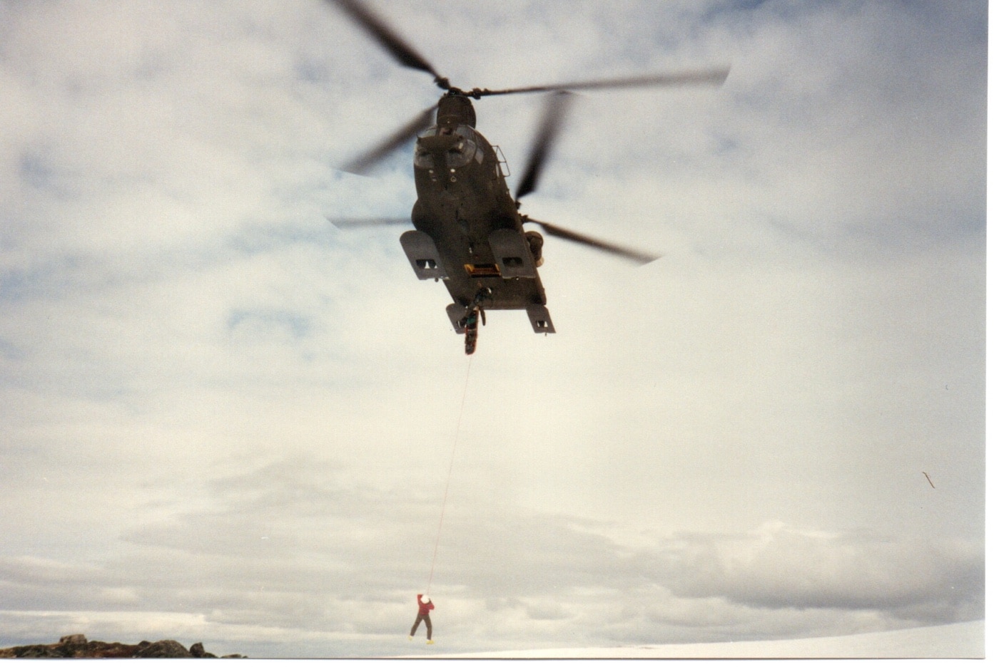 author suspended below a CH-47 Chinook helicopter