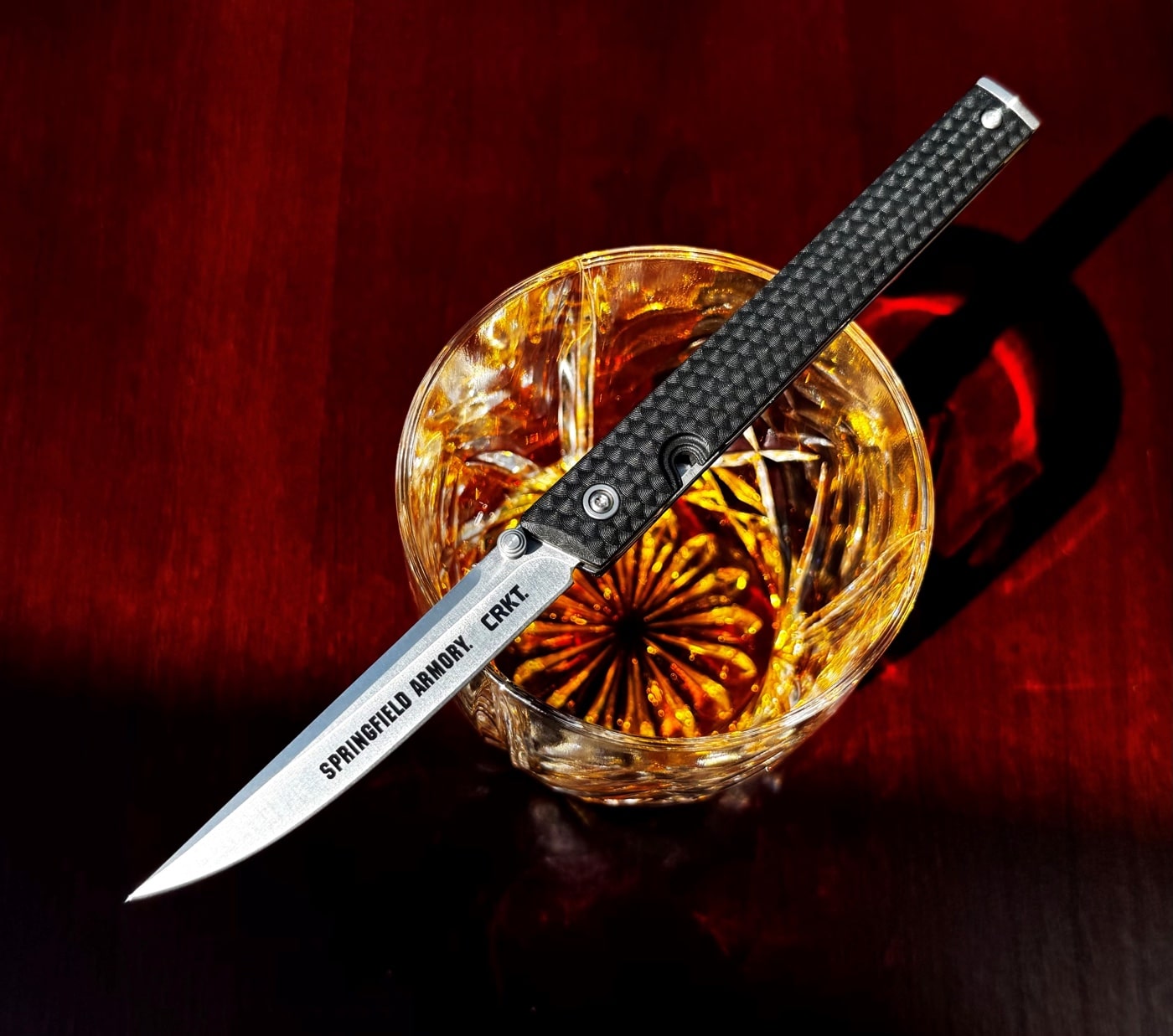 CRKT CEO knife with bourbon whisky