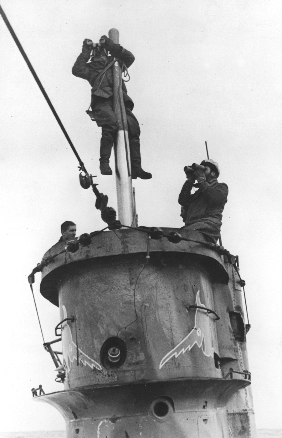 German sailors searching for enemy ships from the tower of their submarine