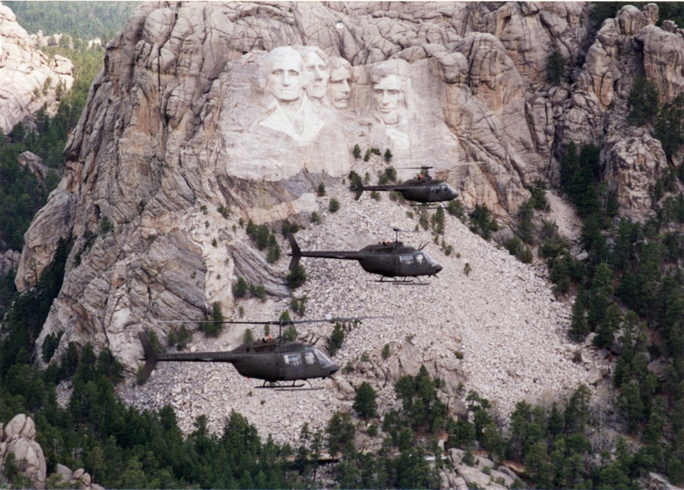 OH-58 helicopters fly by Mount Rushmore