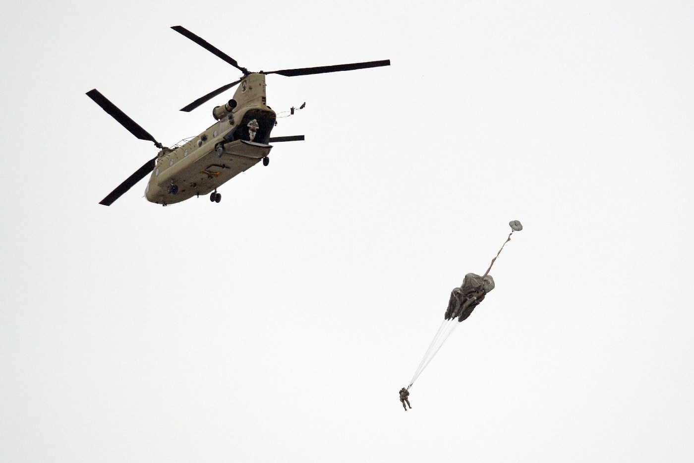 US Army paratroopers jump from CH-47