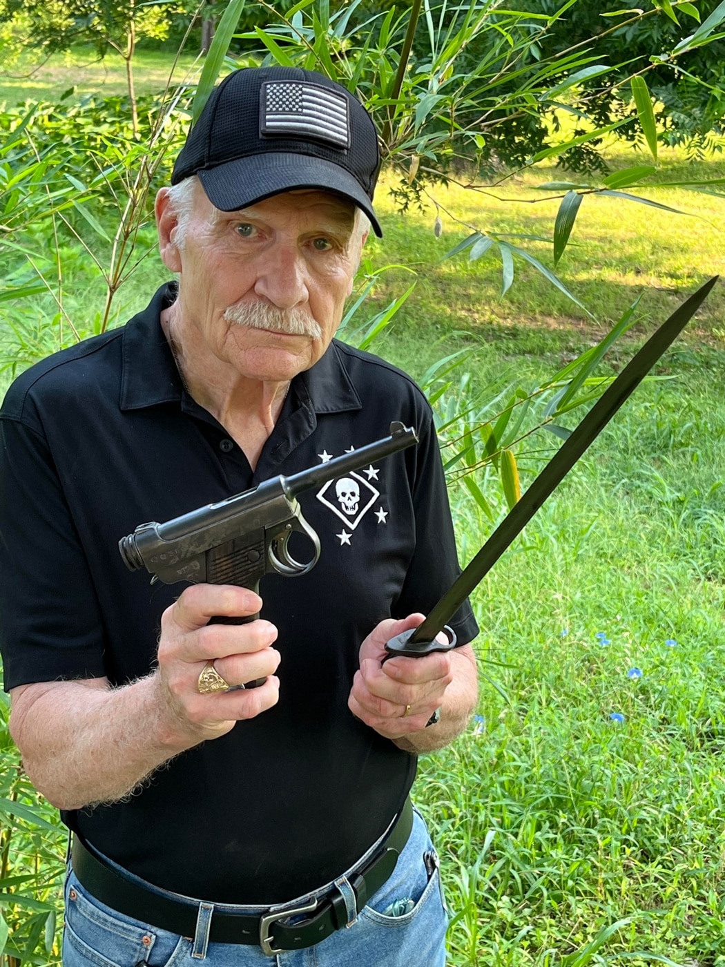 author Dale Dye with Nambu pistol and Japanese bayonet