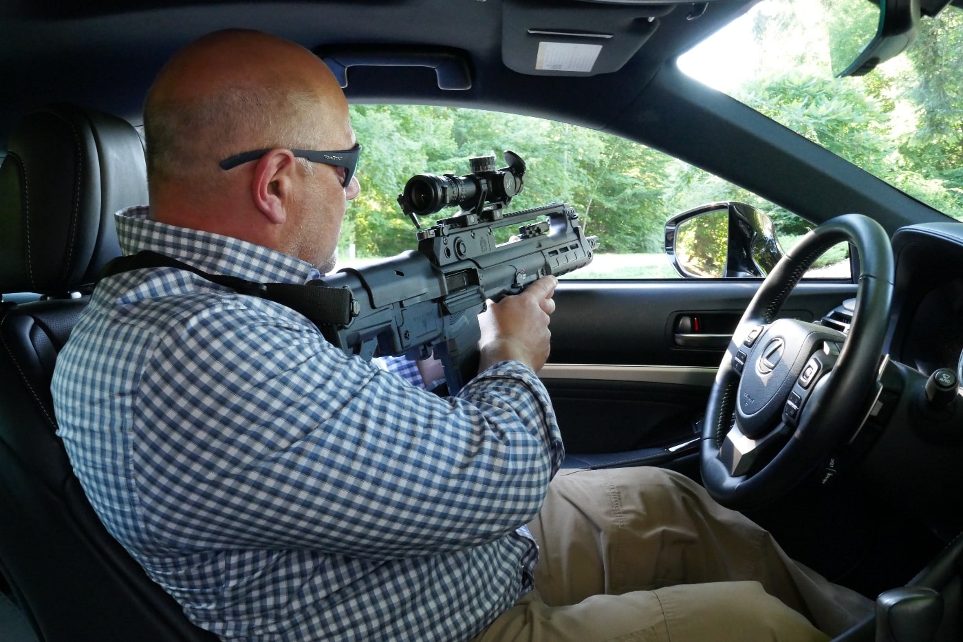 author shooting Springfield Hellion from his car with Nightforce Optics scope mounted