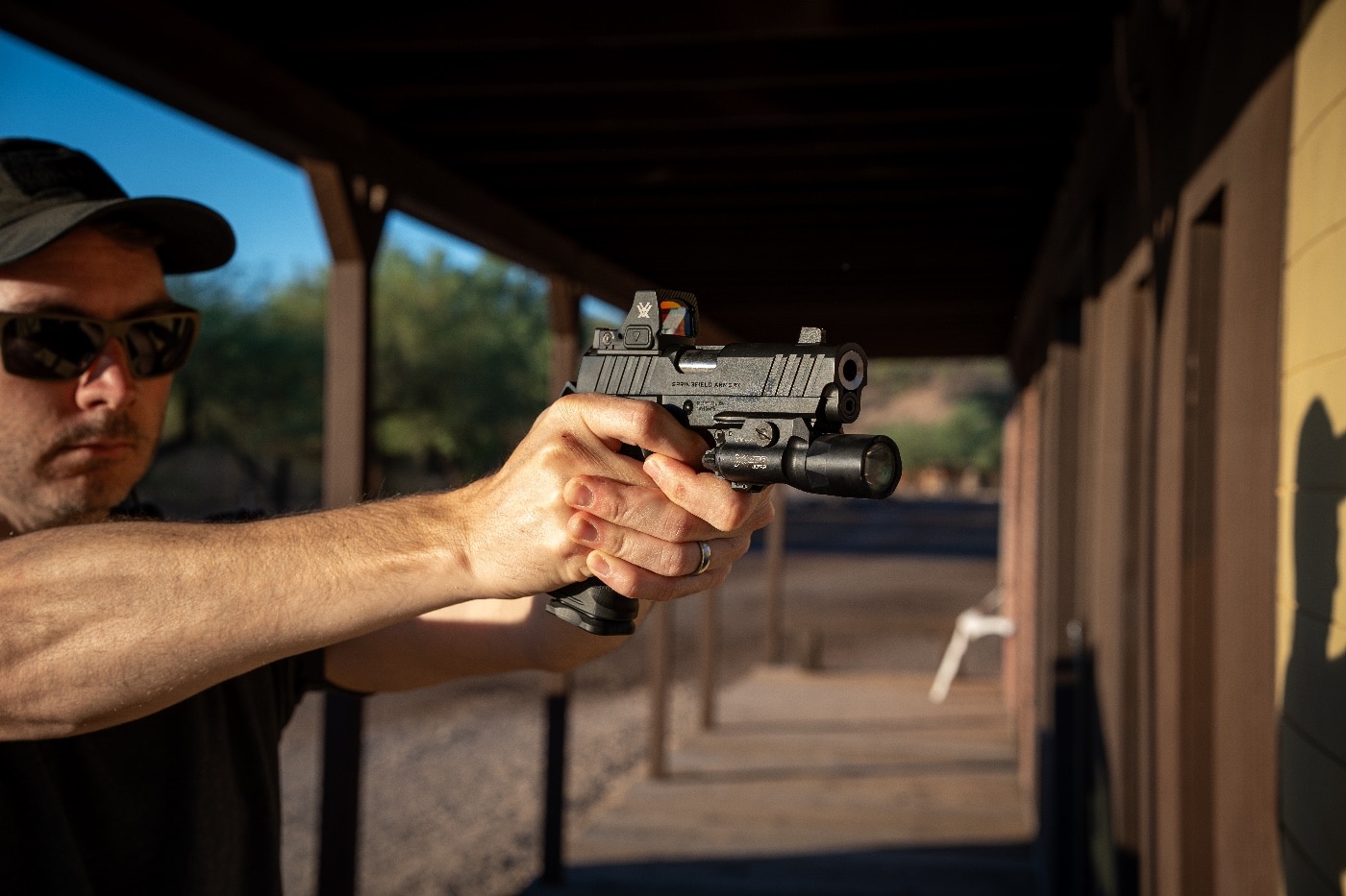 author with pistol at shooting range