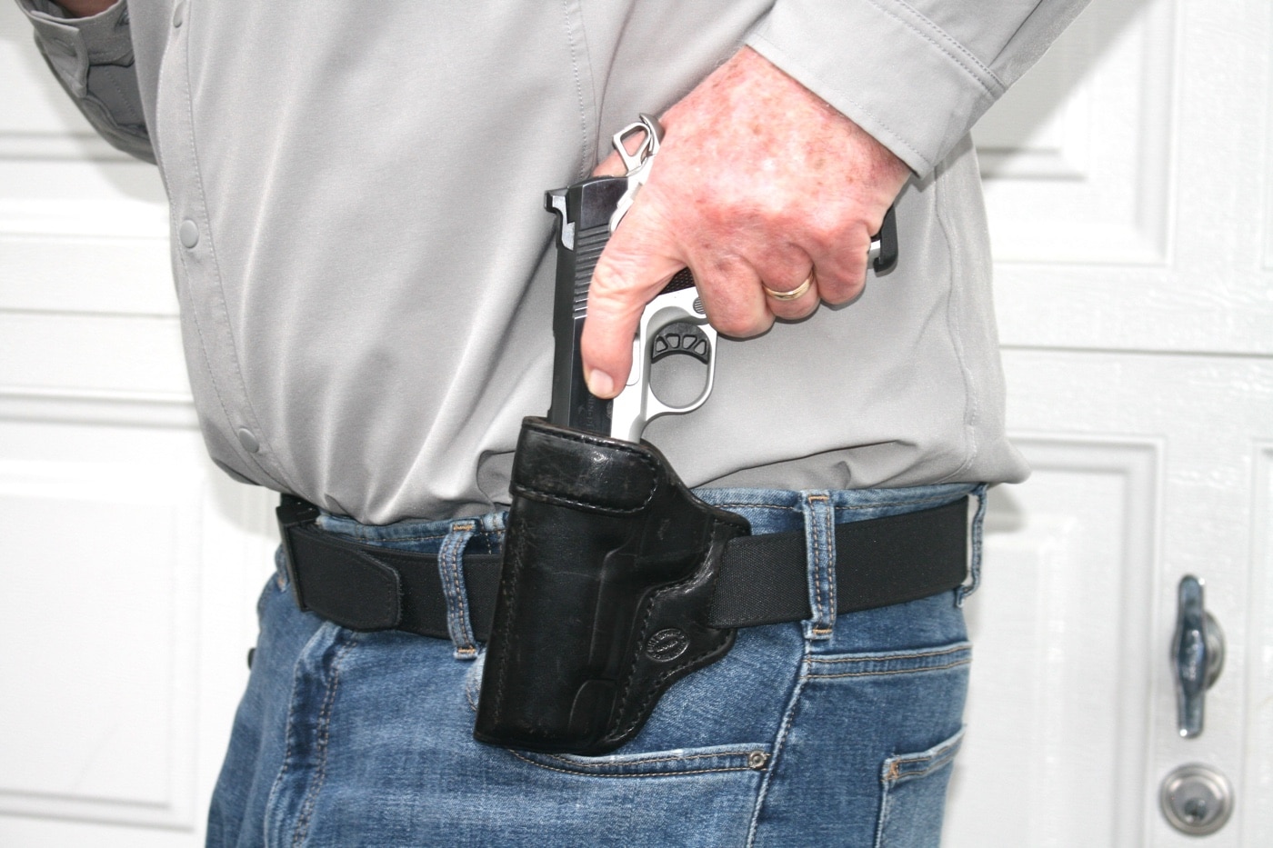 deliberate reholstering of self-defense pistol