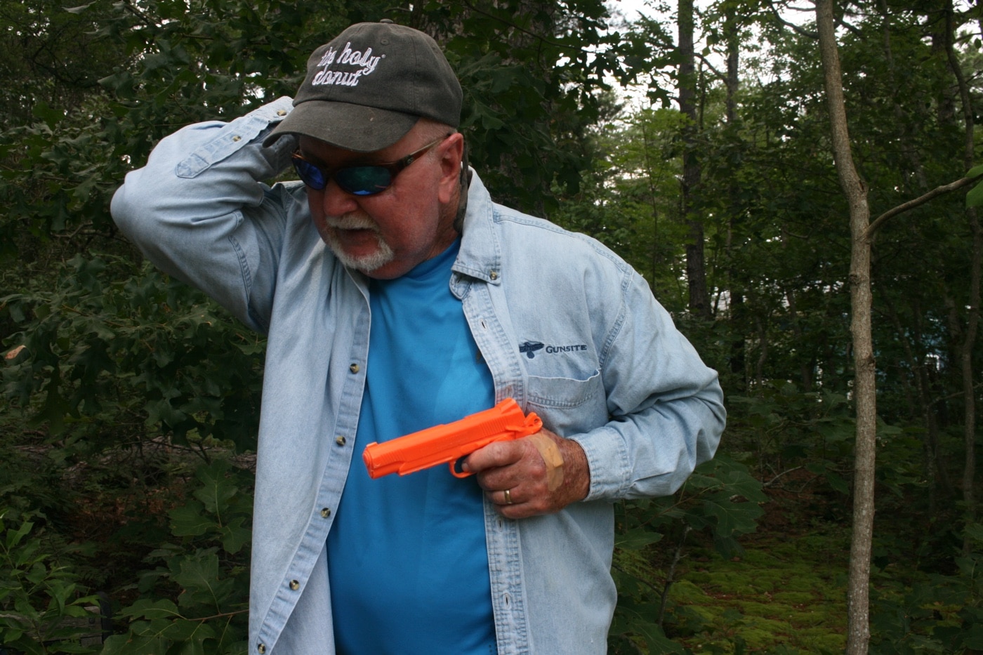 protecting head with gun tucked close to body