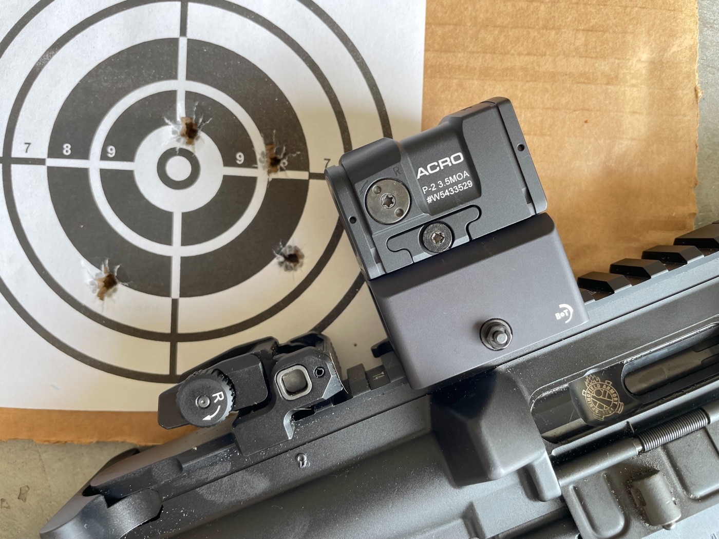 Aimpoint ACRO P-2 mounted on rifle for accuracy testing on the shooting range