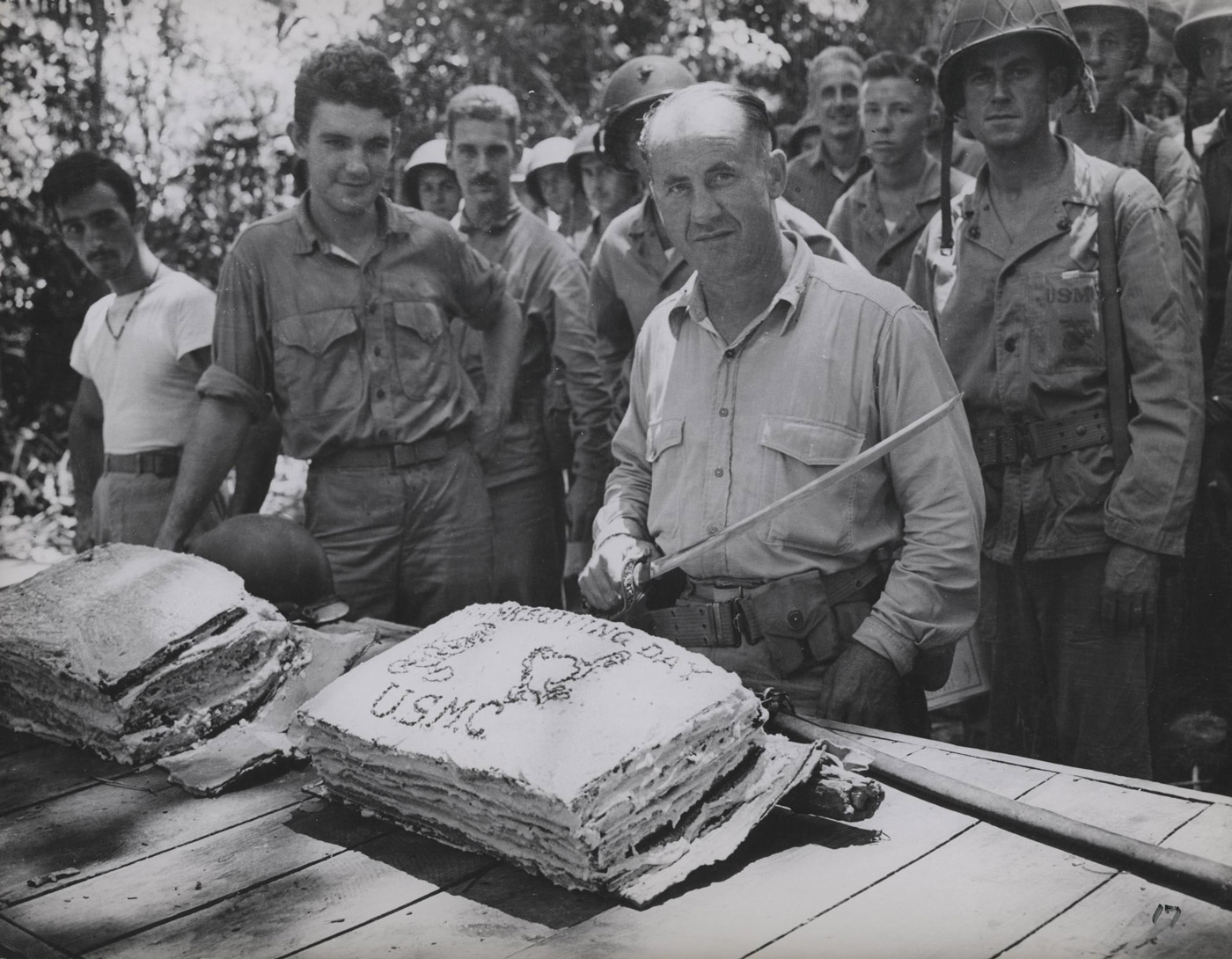 Lt.Col. W.W. Stickney cuts Thanksgiving cake with Japanese sword on Guadalcanal