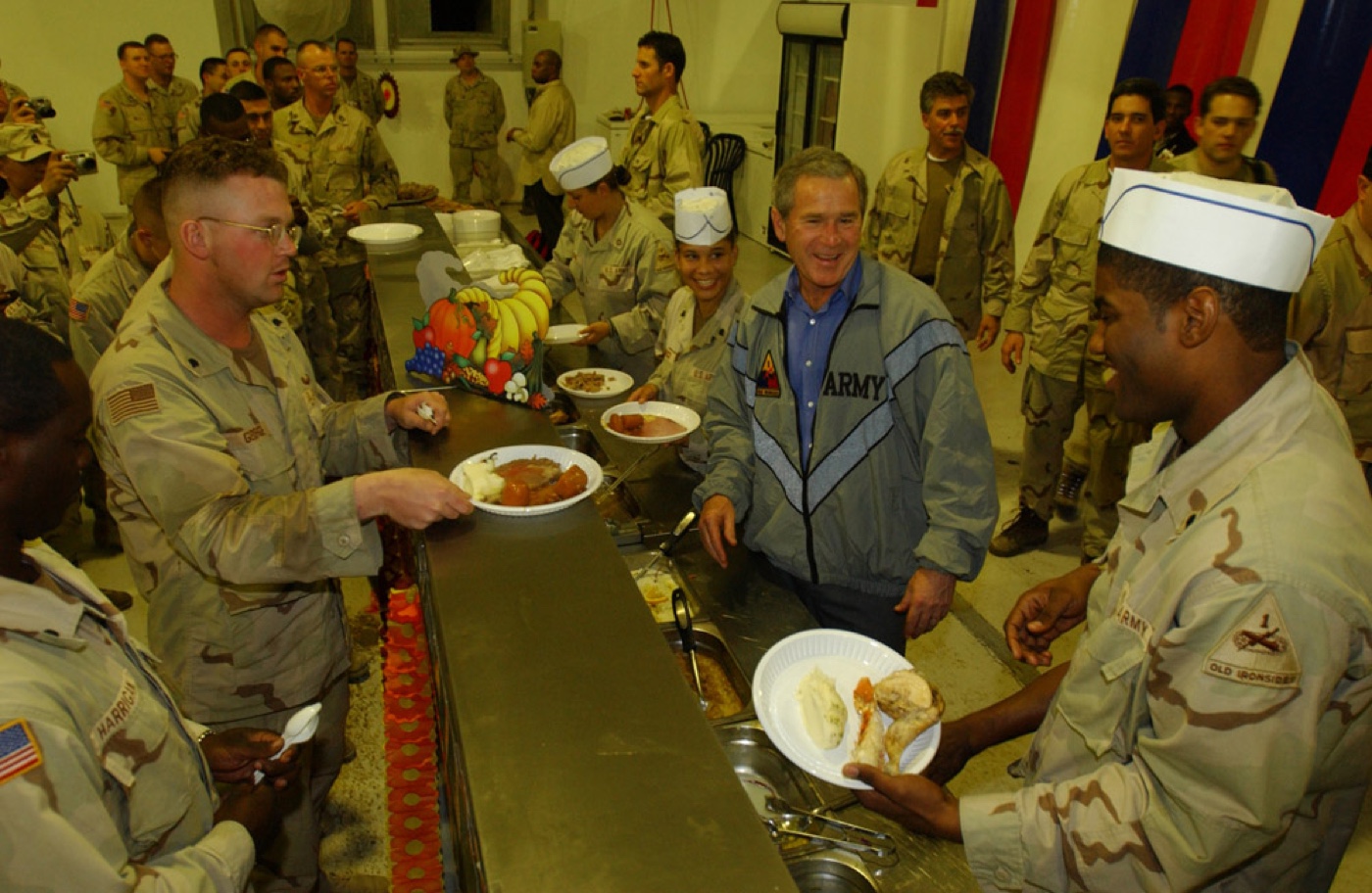 President George W Bush serves Thanksgiving dinner to US troops in Iraq