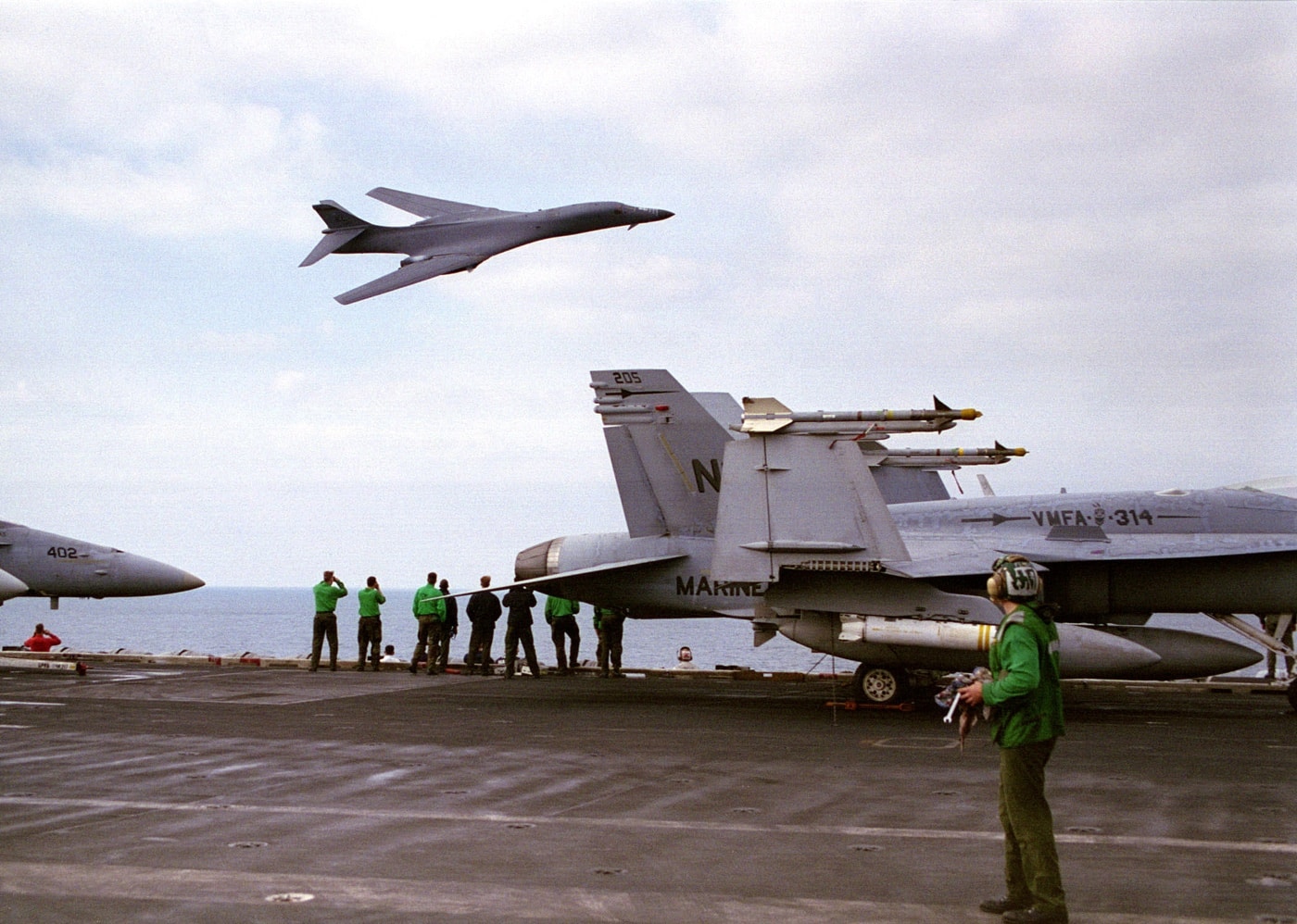 Rockwell B-1B Lancer bomber flies past the USS Nimitz in the Persian Gulf