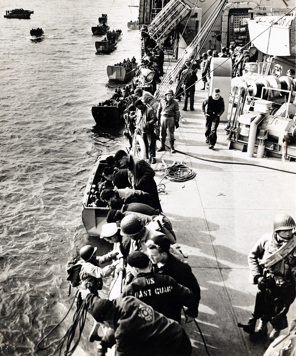 US Coast Guard assists United States of America soldiers onto landing boats during invasion training During Exercise Tiger, an Allied live-fire rehearsal for the Normandy landings, tragedy struck in Lyme Bay when a convoy of landing ships was ambushed by German E-boats. Poor radio frequency coordination left the convoy vulnerable to attack, resulting in significant loss of life. The event underscored the dangers of amphibious warfare during World War II.