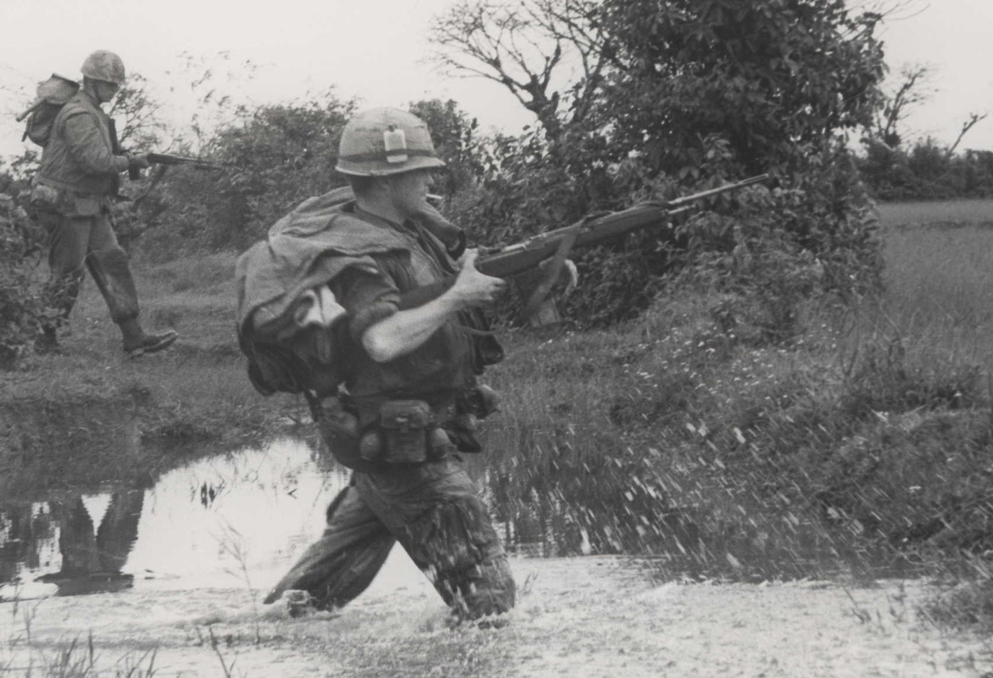 US Marine crosses river with M14 rifle in Vietnam War