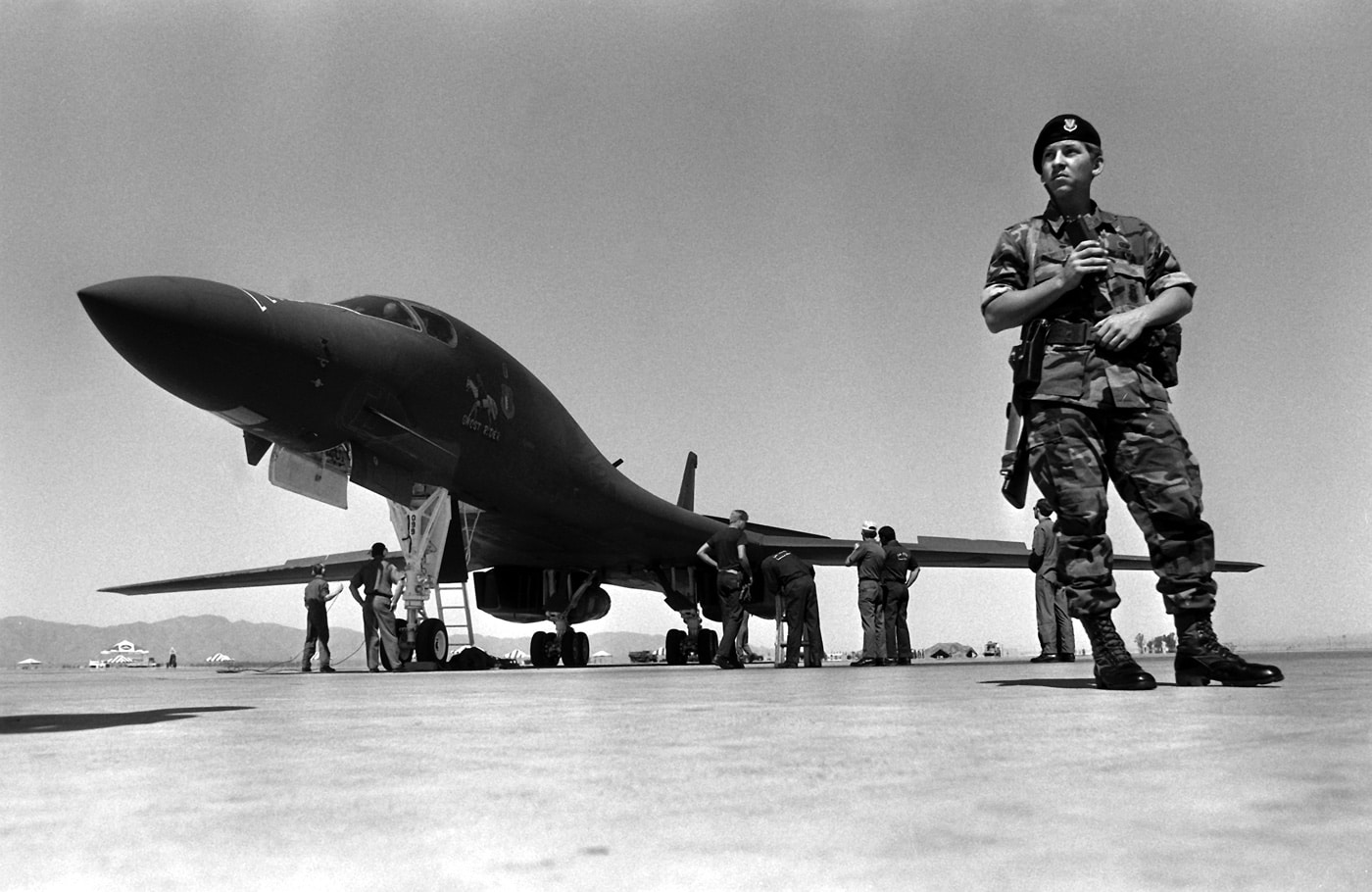 United States Air Force security police officer guards Rockwell B-1 Lancer heavy bomber