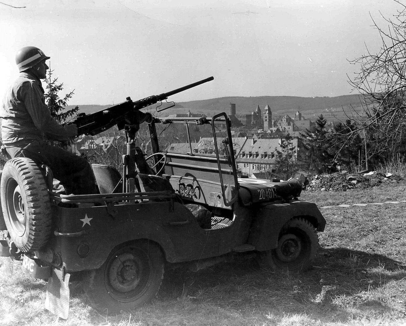 United States Army MP mans M2 Browning machine gun mounted in a Jeep during World War II in Germany